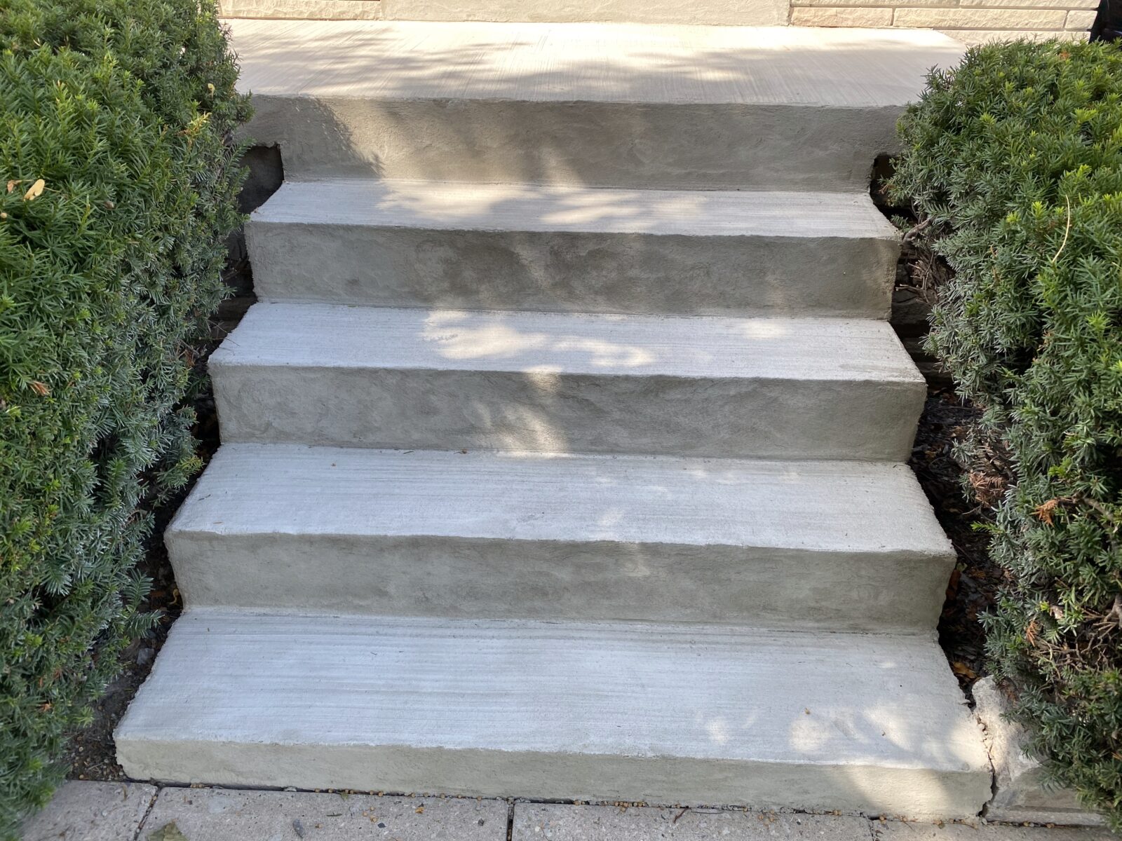 Concrete steps repair in Etobicoke with new smooth finish and modern aluminum railings