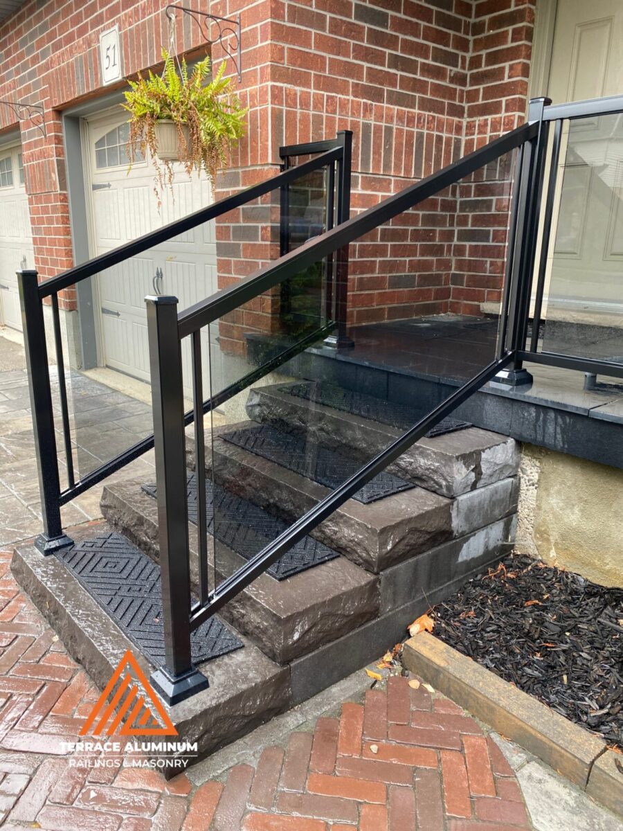 Glass railing installed on a deck overlooking a landscape, providing clear views and contemporary design.
