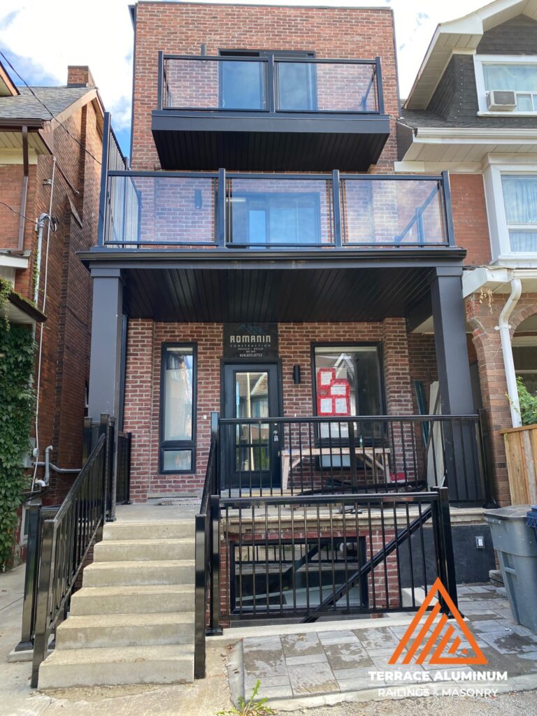 Aluminum and glass balcony railing installed on a home in Oakville with clear tempered glass panels.