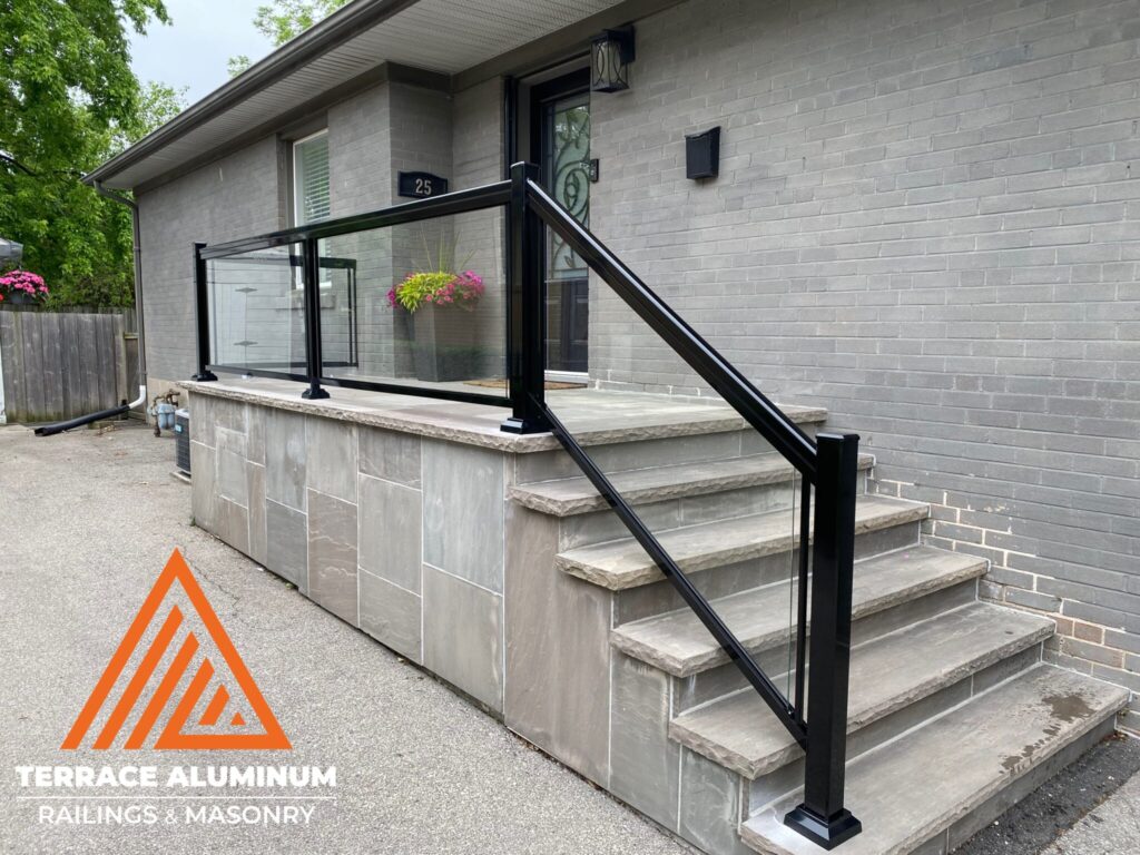 Aluminum and glass railing on flagstone porch in Oakville by Terrace Aluminum Railings & Masonry