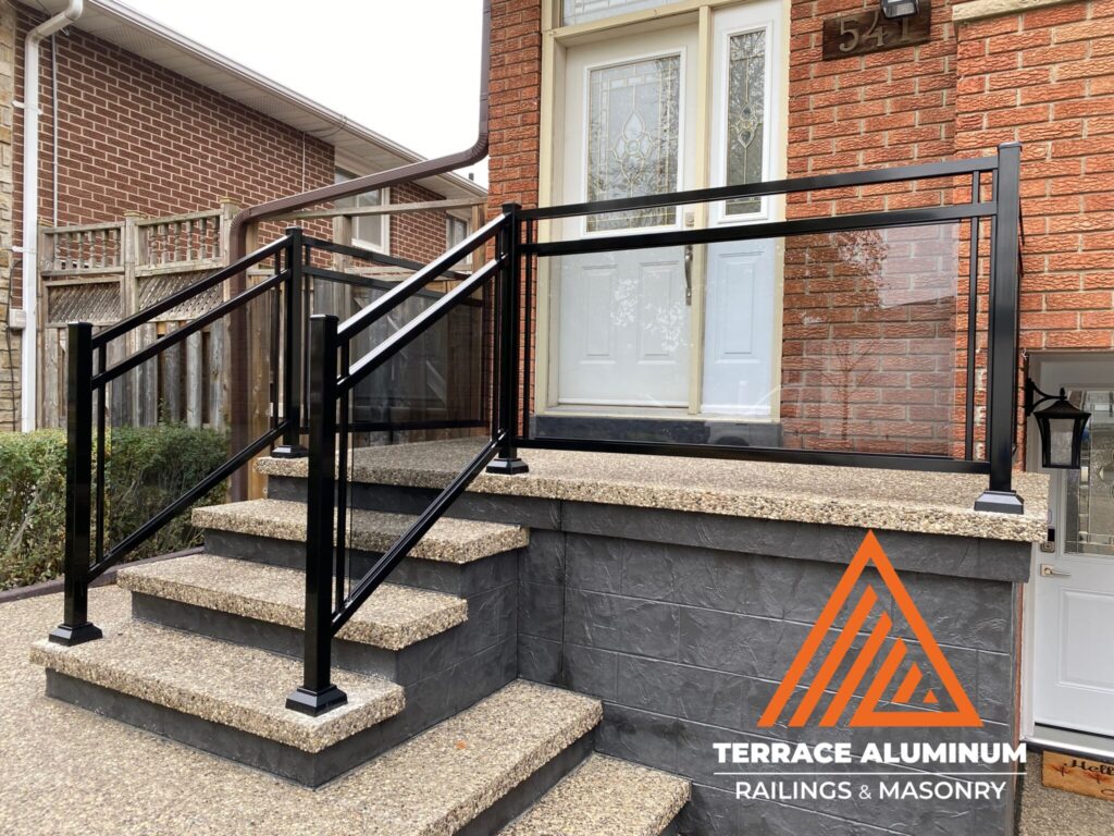 Aluminum and glass railing on front porch in Oakville by Terrace Aluminum Railings & Masonry