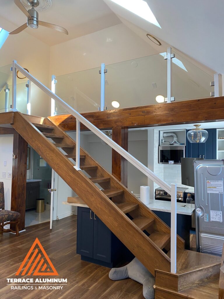 Semi-frameless interior glass railing with white posts in Oakville by Terrace Aluminum Railings & Masonry