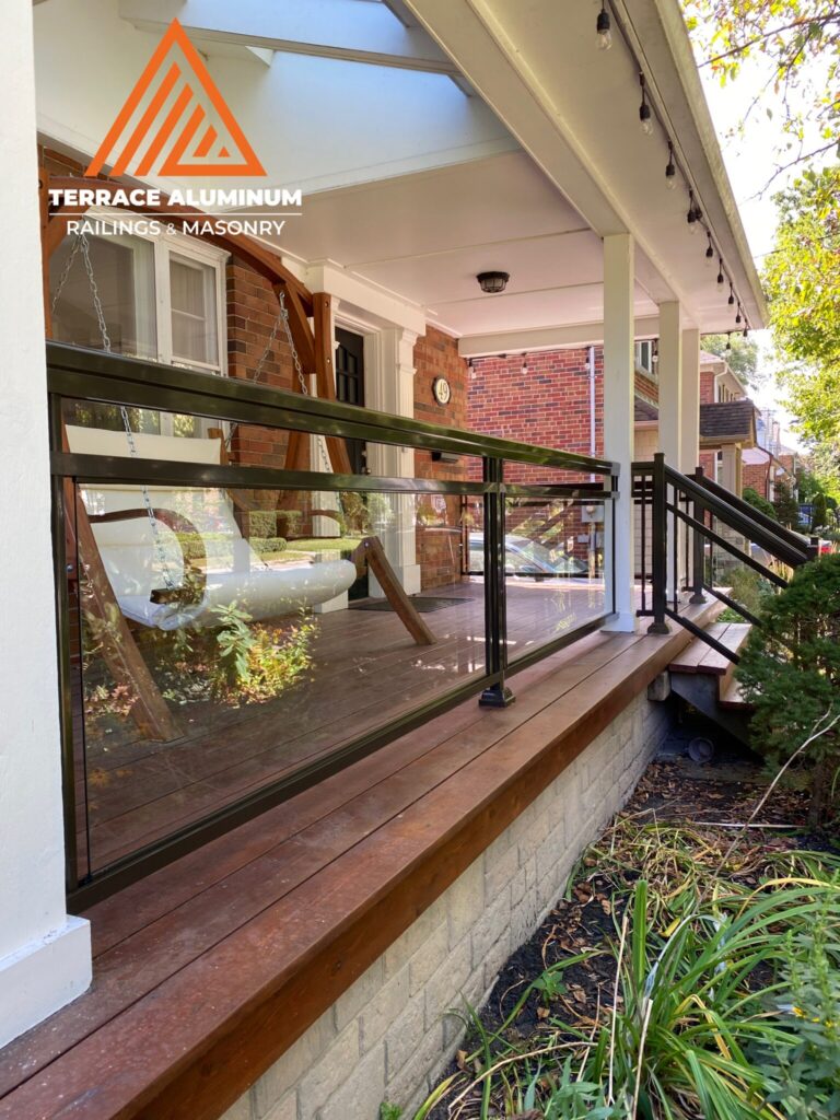 Modern framed aluminum and glass railing installed on a front porch in Oakville.