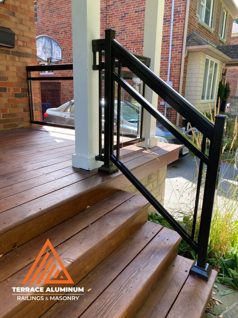 Framed aluminum and glass stair railing installed on exterior steps in Oakville.