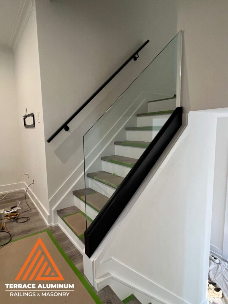 Frameless interior glass railing with base shoe system in Oakville by Terrace Aluminum Railings & Masonry