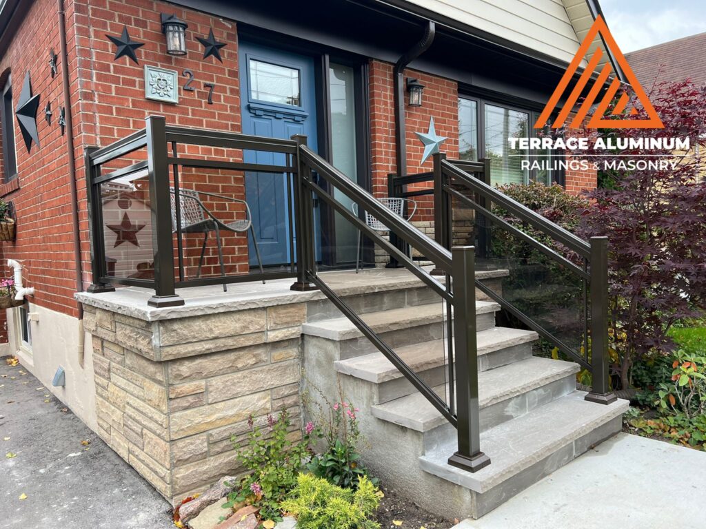 Are glass railings worth it? Framed aluminum and glass railings on a front porch with clear tempered panels and modern design