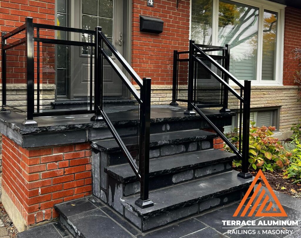 Are glass railings worth it? Framed glass railings with tinted tempered panels on a front porch providing privacy and modern style
