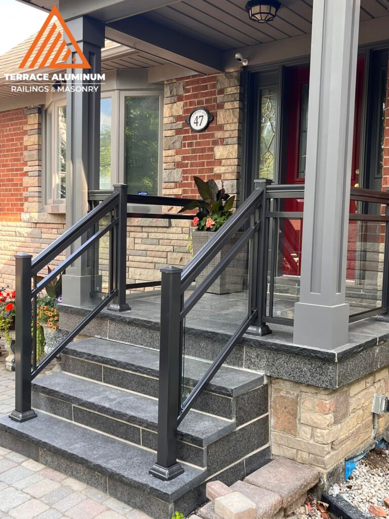 Are glass railings worth it? Framed glass railing with aluminum posts and clear tempered panels creating a modern, safe exterior design