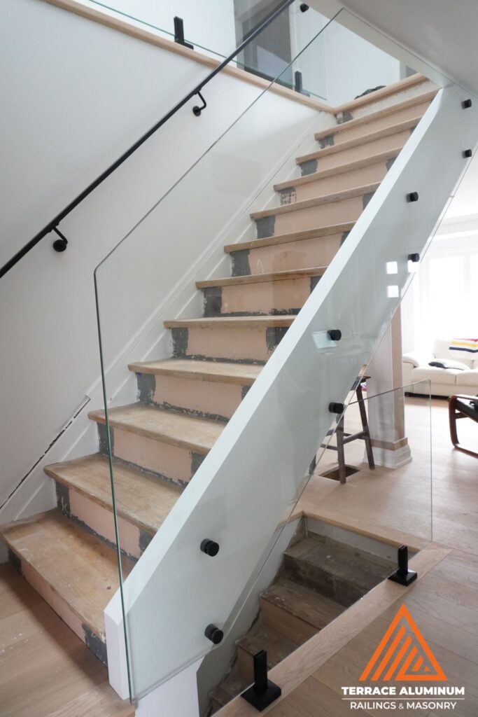 Interior glass railing with standoffs and spigots in Oakville by Terrace Aluminum Railings & Masonry