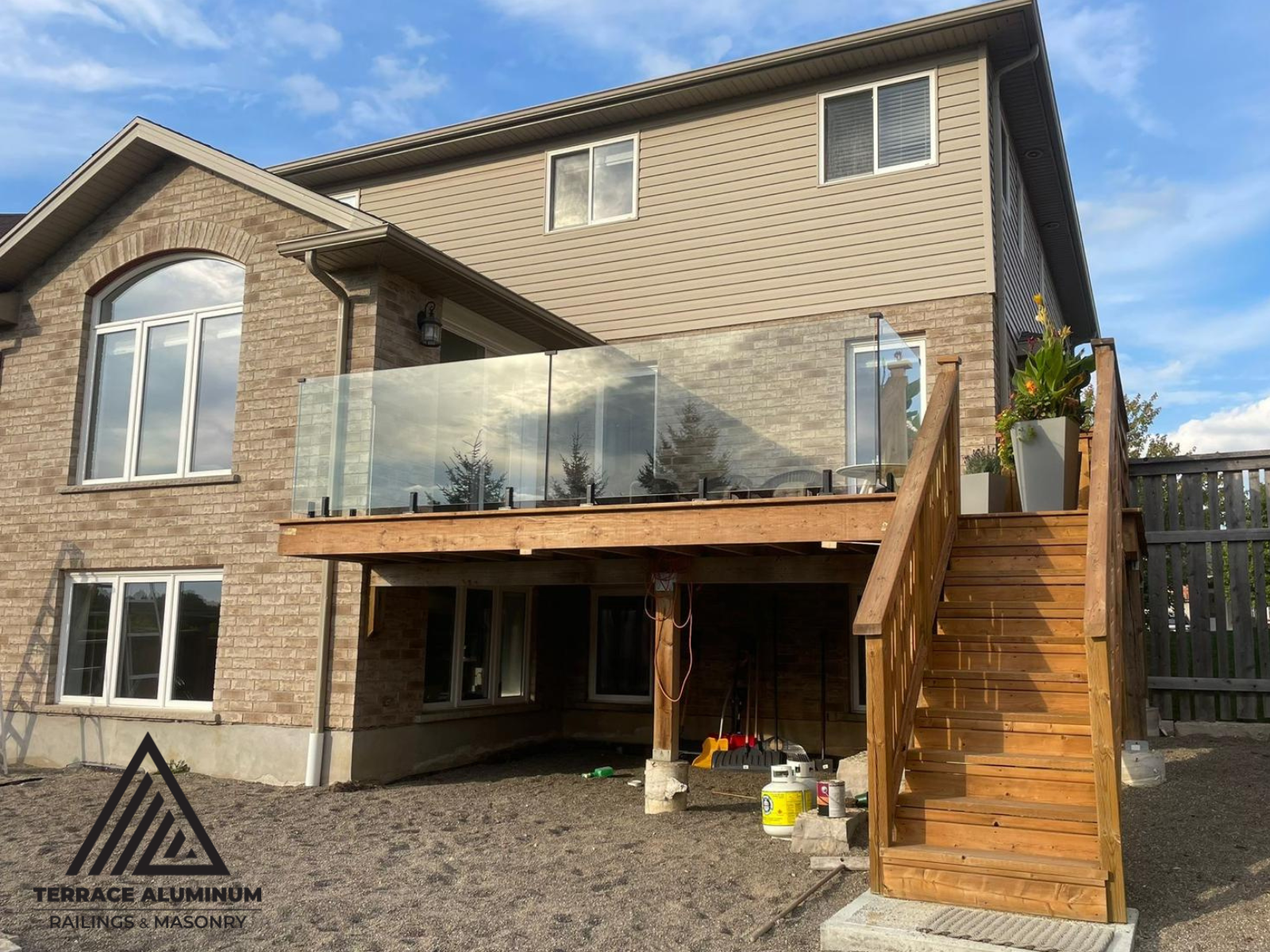 Frameless glass railing on a deck in Hamilton installed by Terrace Aluminum Railings, featuring 12mm tempered glass panels and stainless steel spigots for a modern open design."