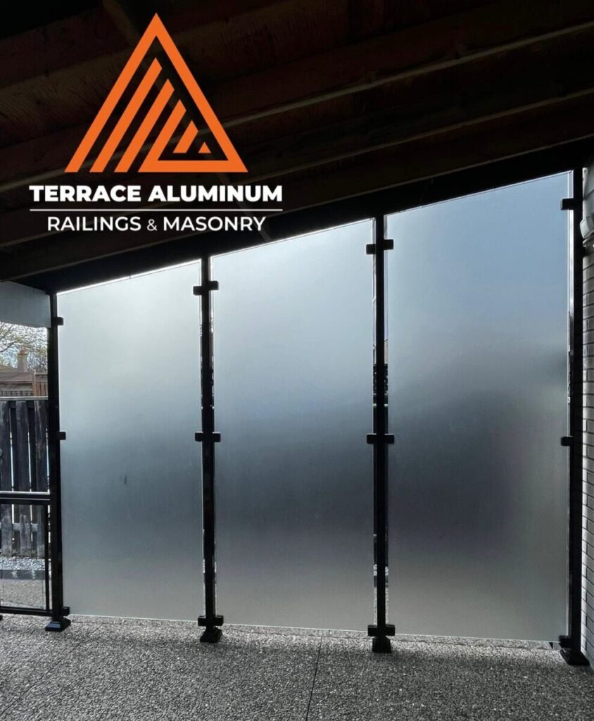 Frosted glass privacy wall installed on a deck in Oakville with aluminum posts.