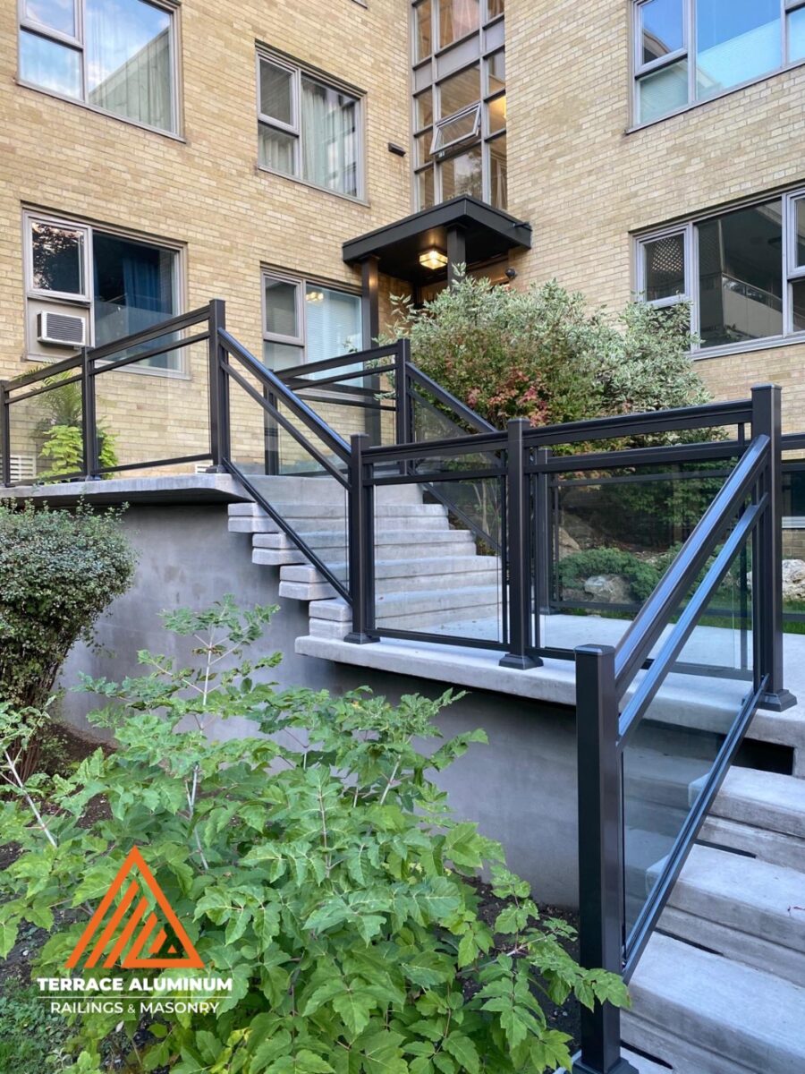 Framed aluminum glass railing on a balcony in Hamilton installed by Terrace Aluminum Railings, featuring clear tempered glass panels and powder-coated aluminum posts for a modern look.