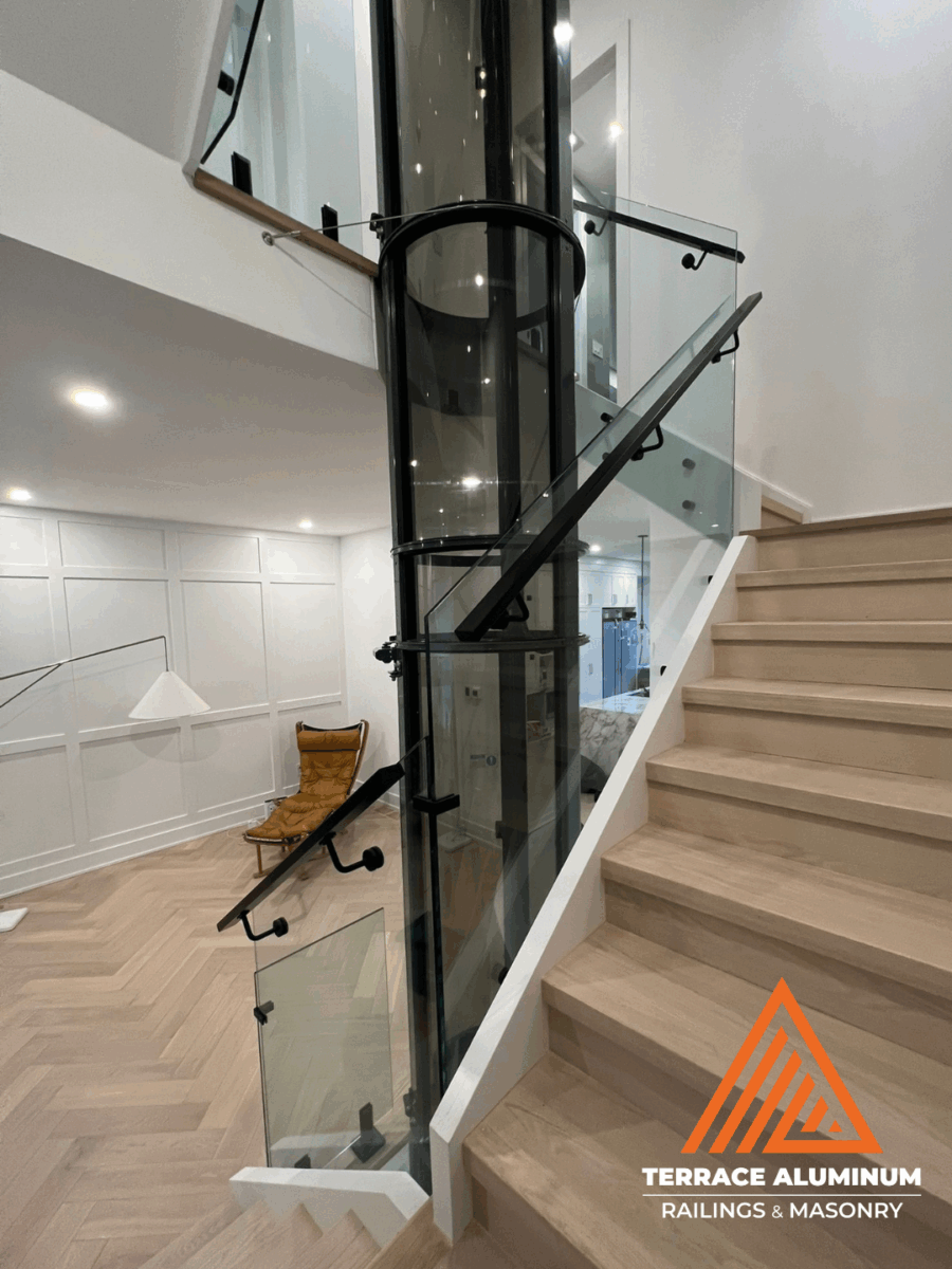 interior glass railing in an ultra-modern Hamilton home installed by Terrace Aluminum Railings, featuring 12mm clear tempered glass panels and stainless steel fittings for a sleek contemporary design.