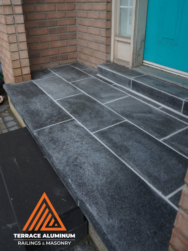 Flagstone front porch installed on a concrete base showing long-term durability and stability