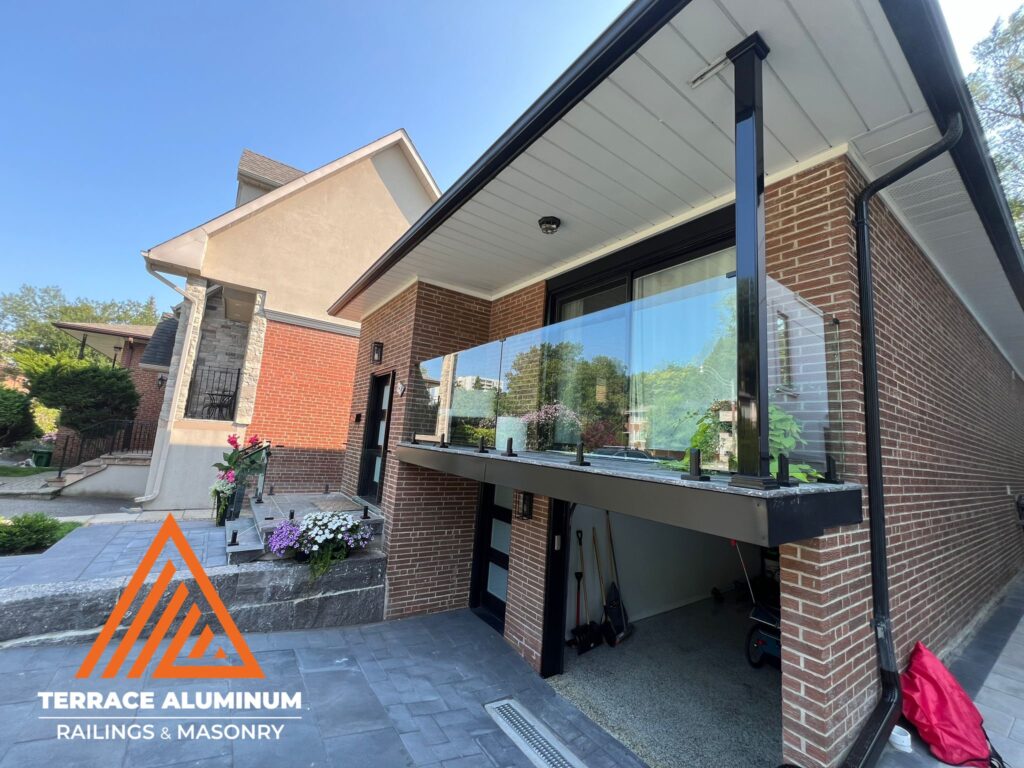 Glass railing installed on a front porch creating an open and modern exterior appearance