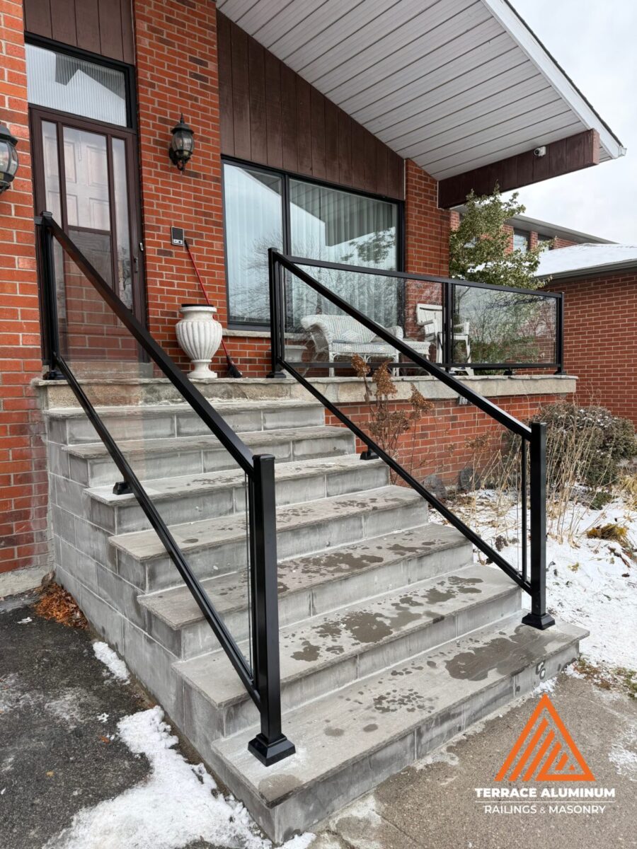 After photo of modern glass railing on rebuilt stairs and porch in Mississauga