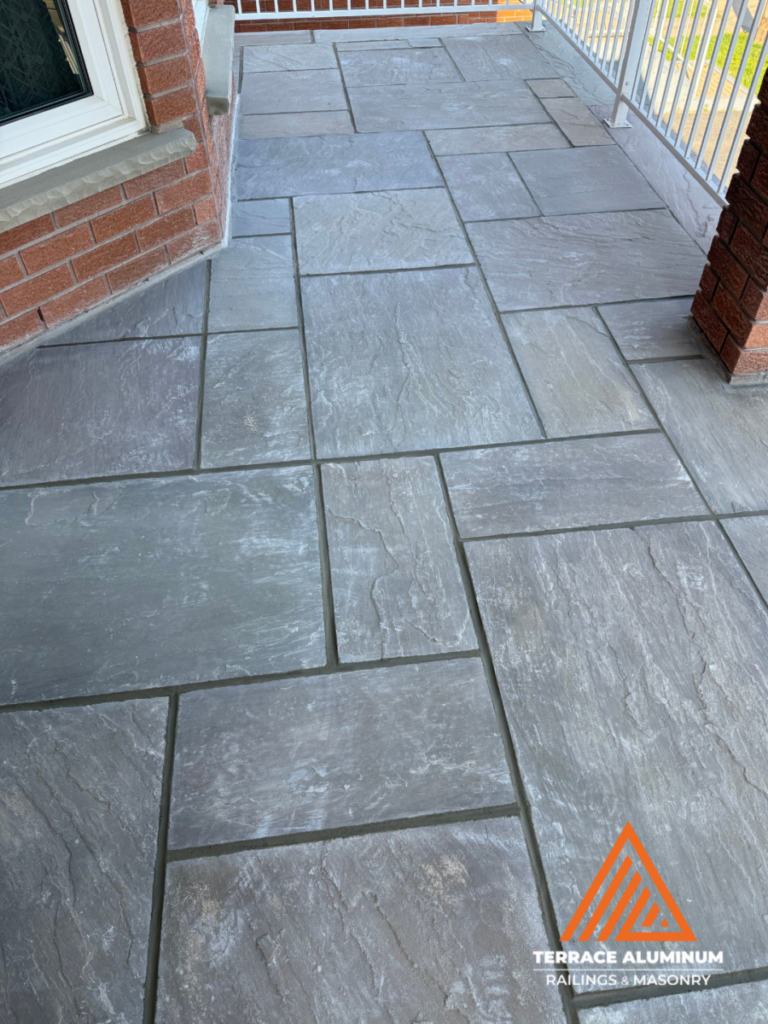 Flagstone repair Mississauga after front porch restored with reset stone