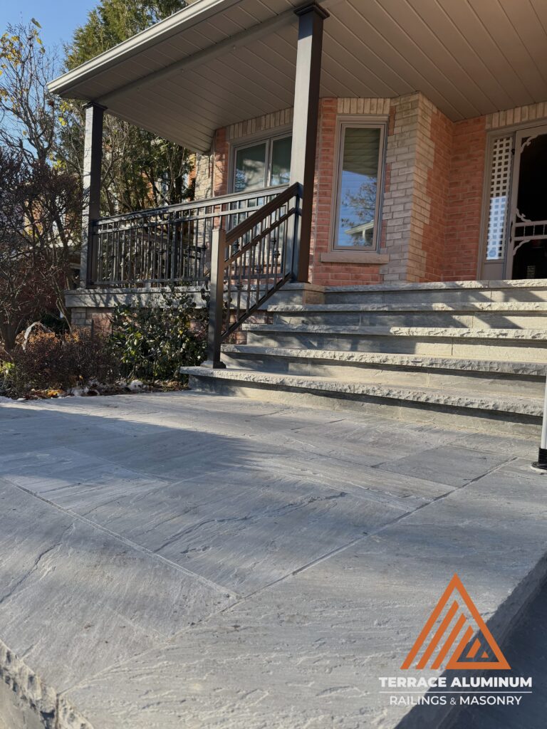 Flagstone front walkway and porch installed as part of a hardscaping project in Oakville