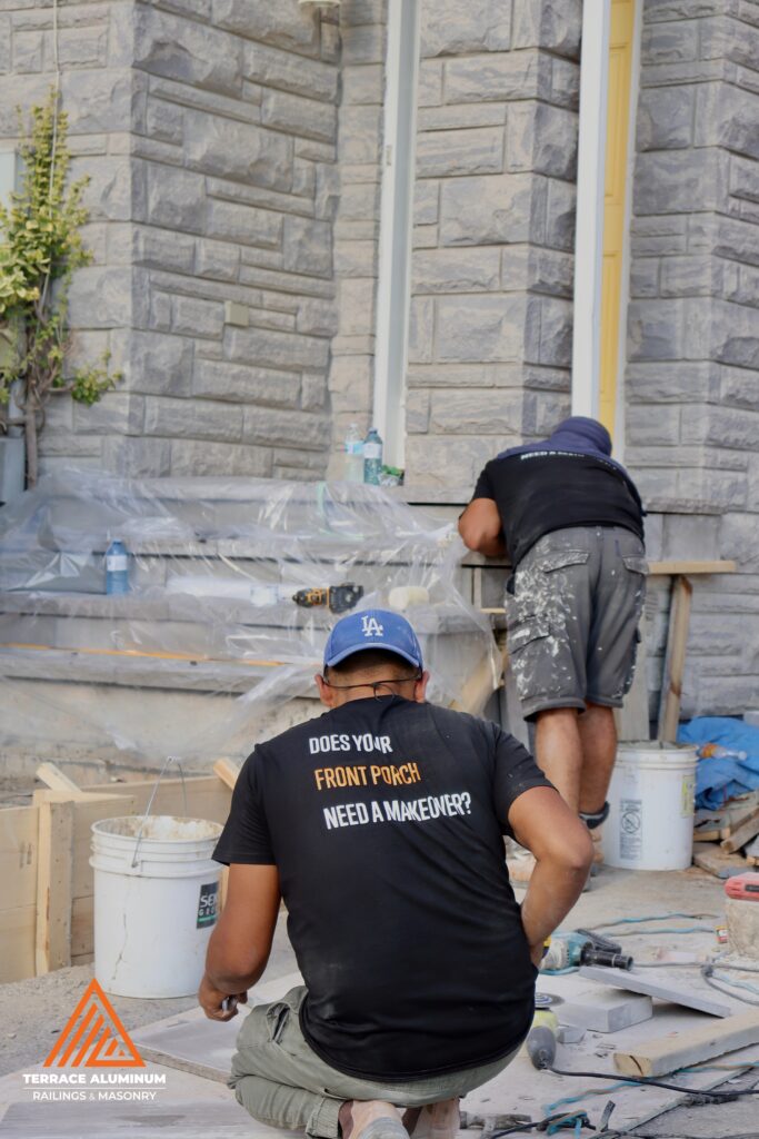 Workers preparing a front walkway for concrete during a Hardscaping Oakville project