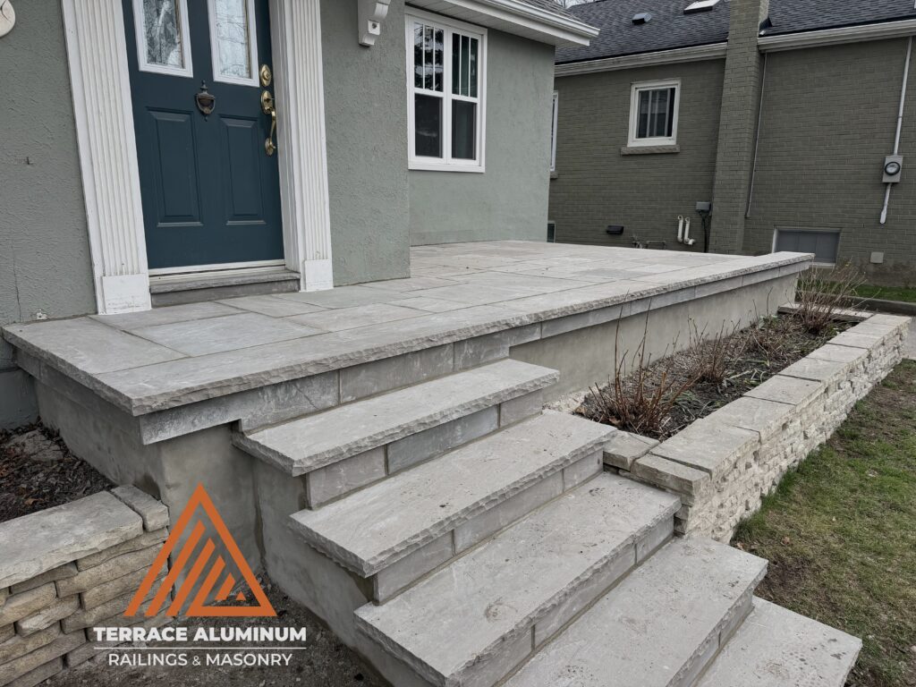 Natural flagstone porch and front walkway for a residential hardscaping project in Oakville