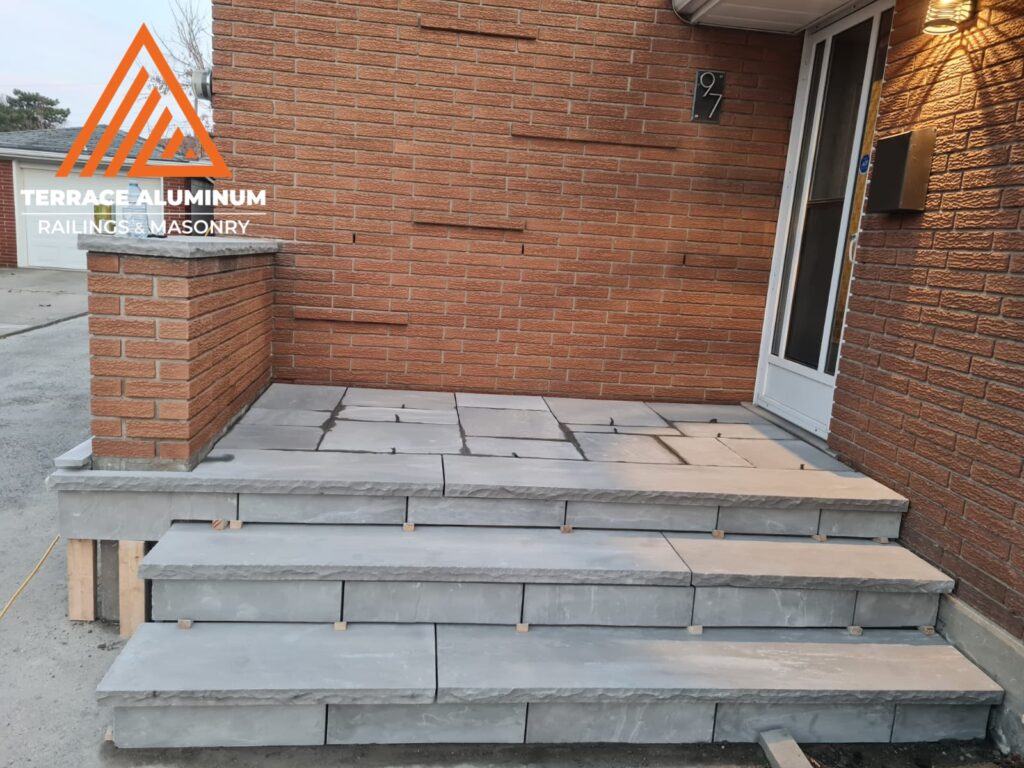 Flagstone overlay on a small front porch for hardscaping services in Etobicoke.