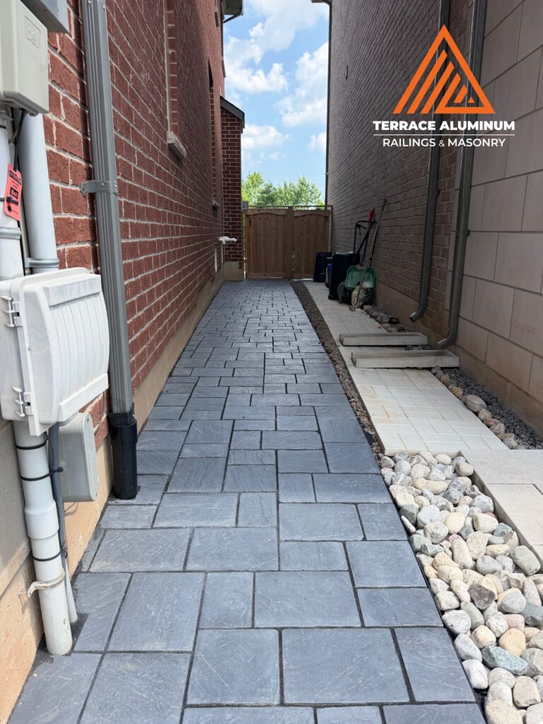 Cobblestone-style interlock walkway installed as part of a Hardscaping Oakville project