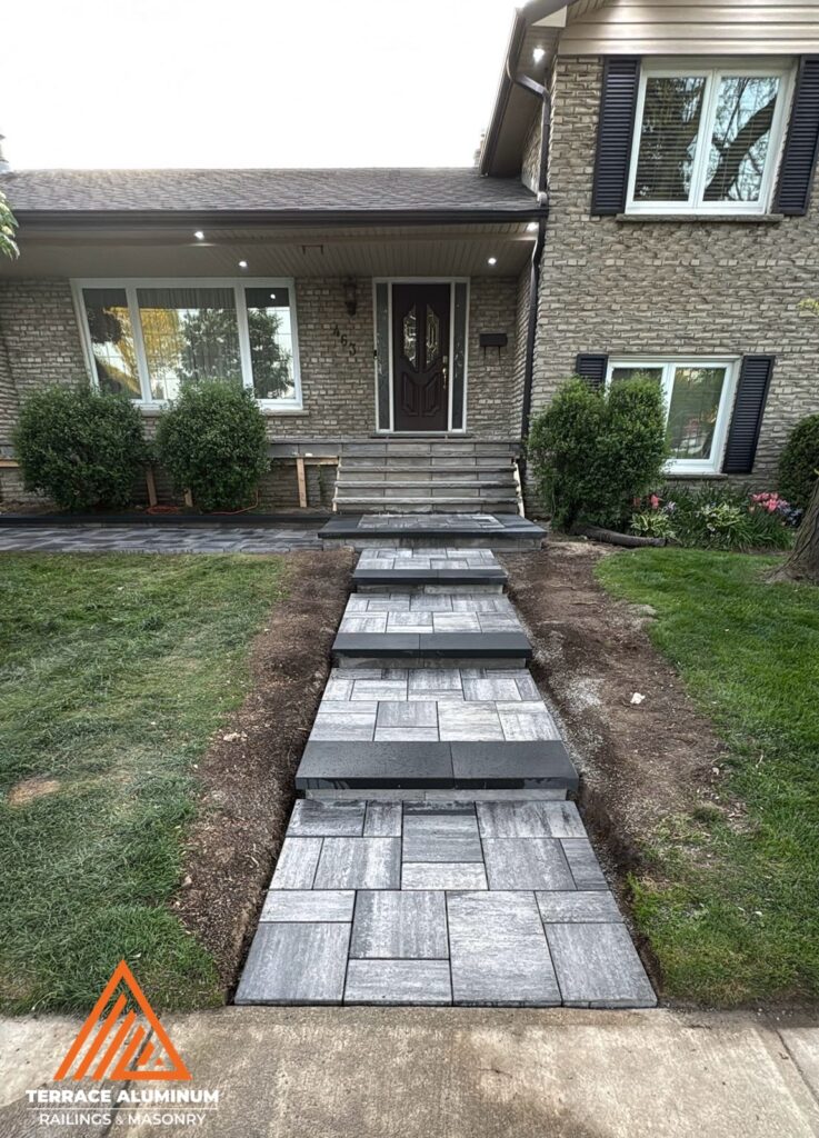Interlock steps leading to a flagstone porch and stairs completed for a hardscaping services project in Etobicoke