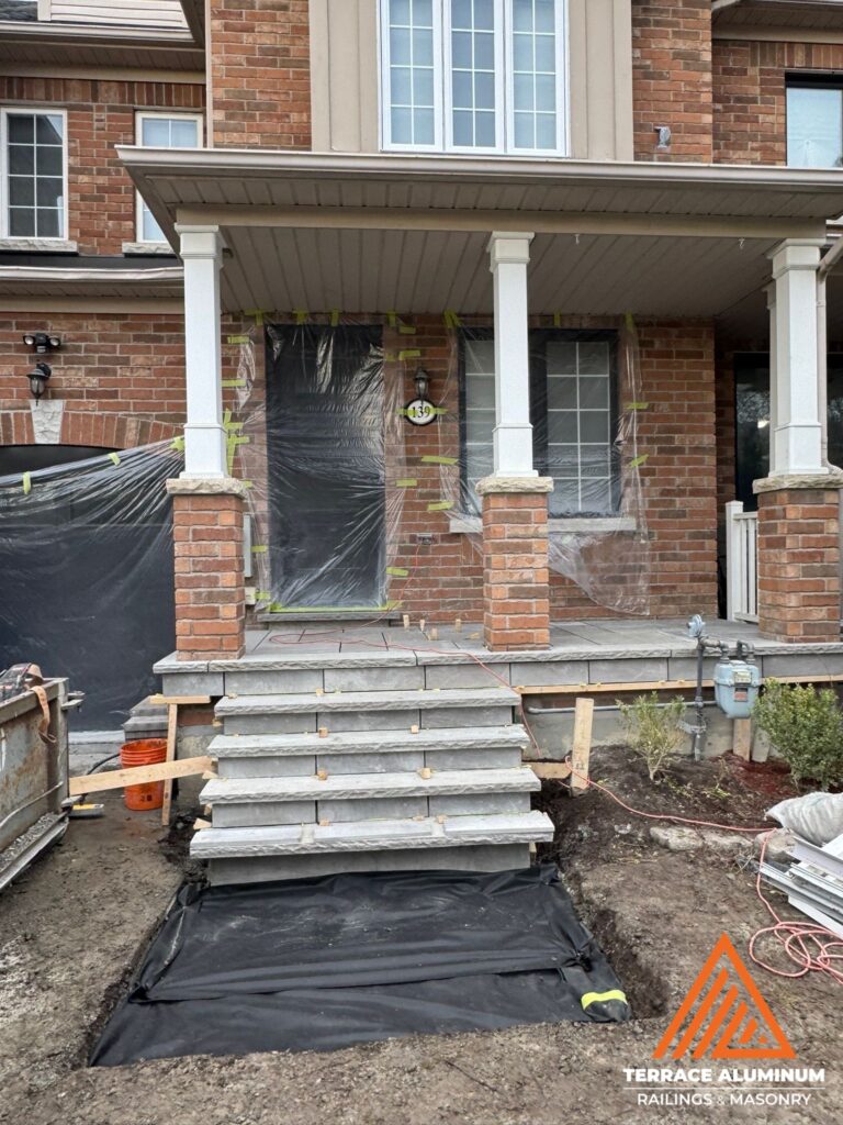 Flagstone porch completed with the interlock area excavated and ready for screening for hardscaping services in Etobicoke.