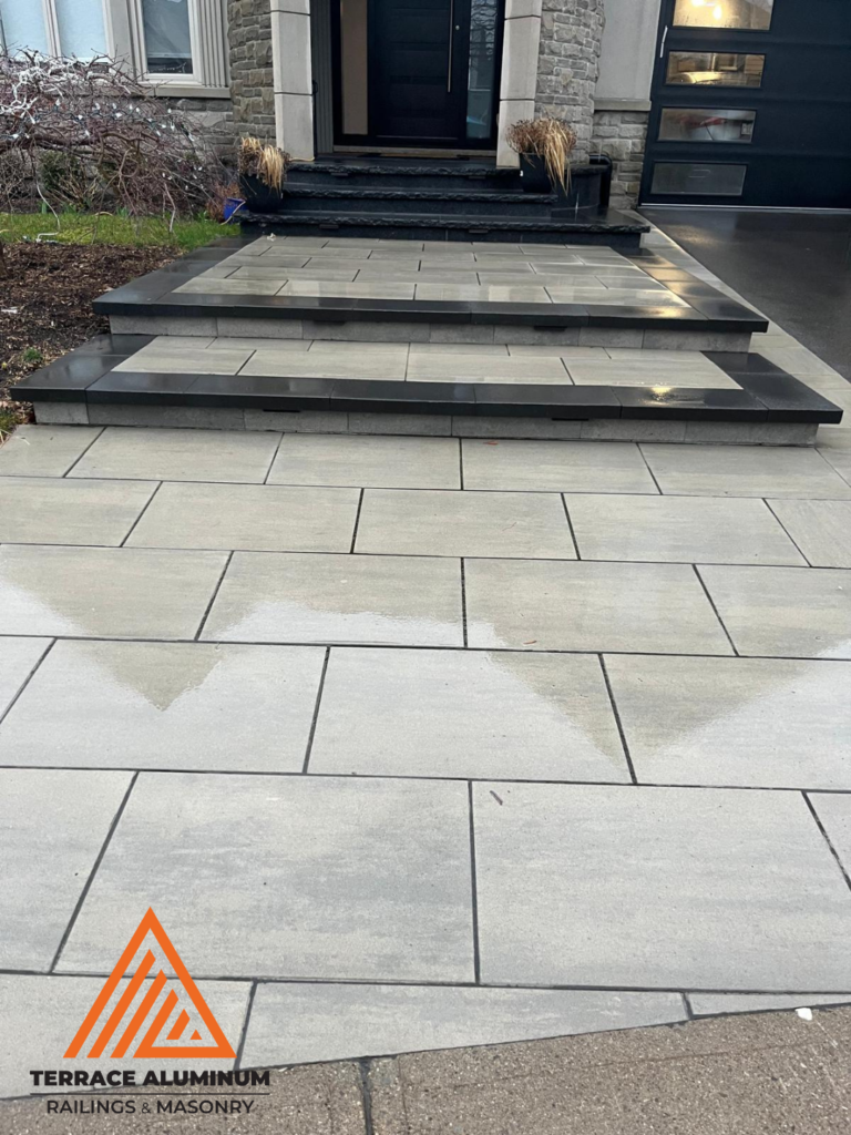 Multiple interlock landings leading to a front porch as part of a hardscaping project in Oakville