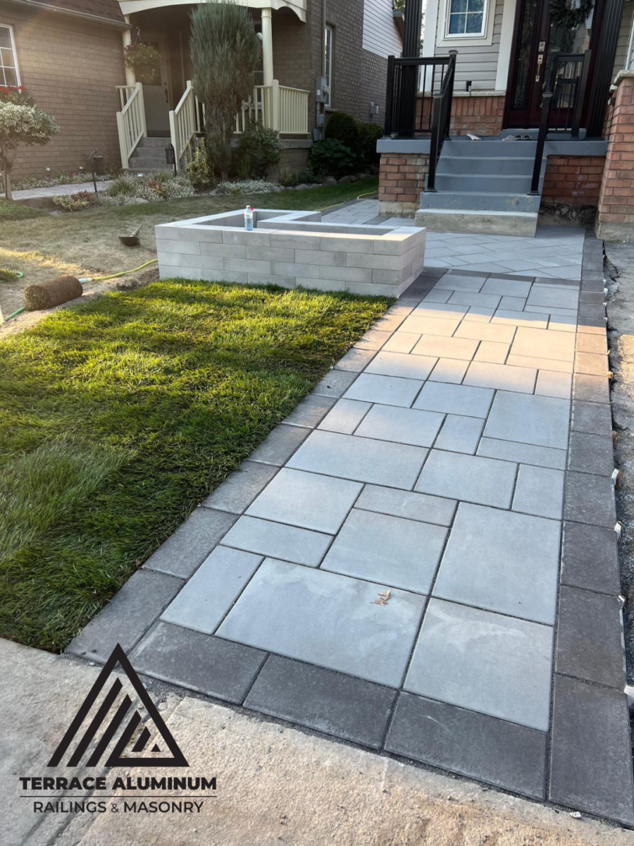 Flagstone front porch with an interlocking paver walkway completed as part of a Hardscaping Oakville project